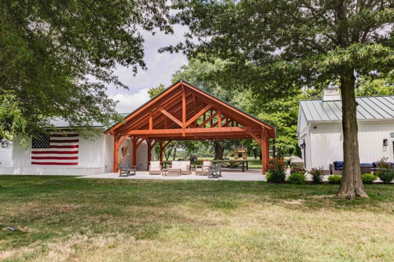 Back view of 38x30 Kingston Pro Timber Frame Pavilion with flag.