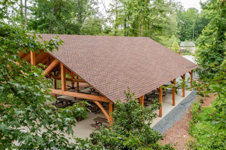 40x60 Kingston Timber Frame Pavilion through the trees of Edgewater, Maryland