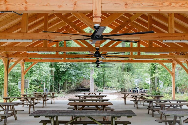 Tables underneath ceiling fan and structure of 40x60 Kingston Timber Frame Pavilion
