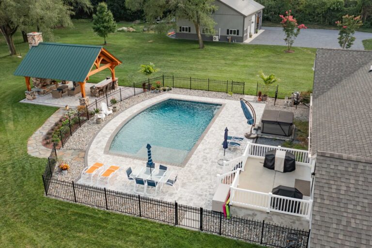 Above 18x20 Kingston Pro Timber Frame Pavilion, pool, and primary home