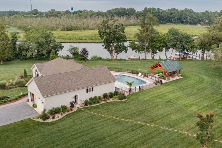 Behind home with view of pool, lake, and 18x20 Kingston Pro Timber Frame Pavilion