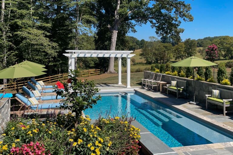 8x14 White Cancun Vinyl Pergola, view from garden over pool