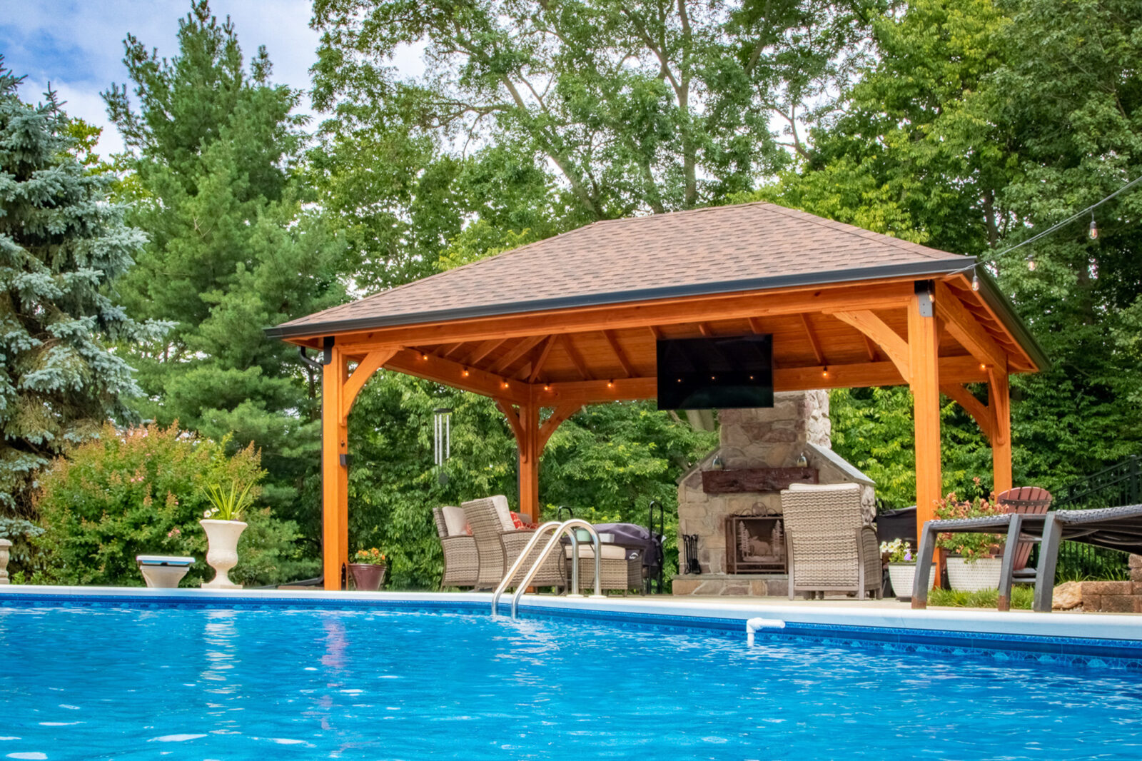 Poolside pavilion lighting with interior lights dotted along the beam