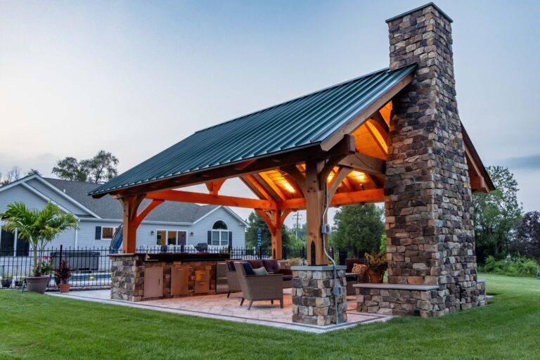 Pavilion lighting-ceiling lights at dusk-back of stone fireplace visible from exterior