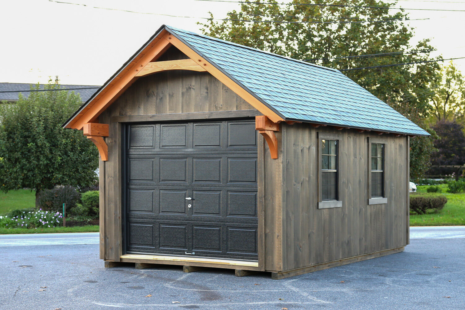 York Timber Frame Shed in driveway with garage door and windows