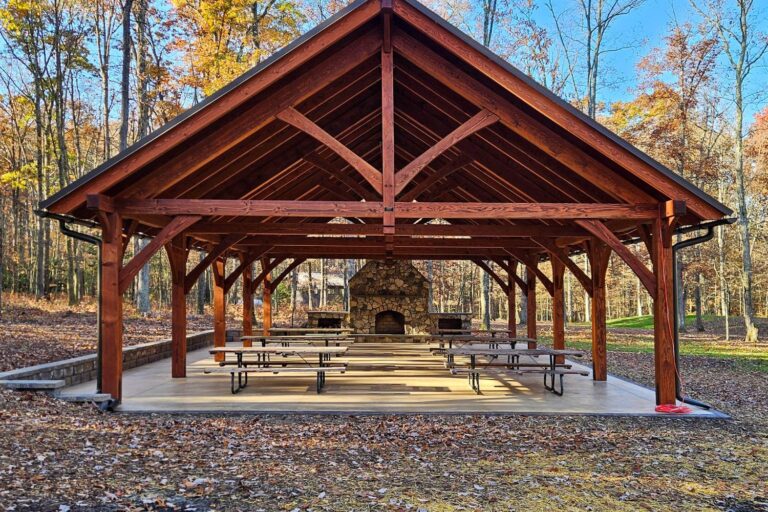 Front view of 30x50 Kingston Pro Timber Frame Pavilion in Mill Hall PA with tables and fireplace in background