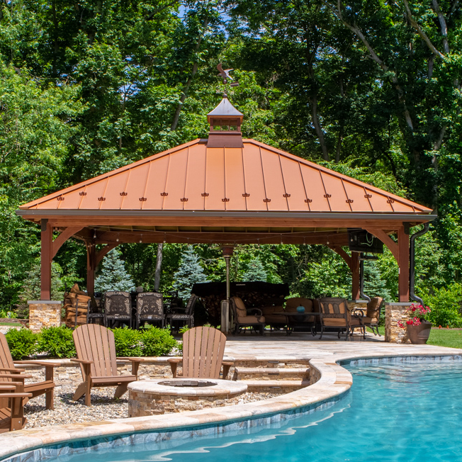 front of a beautiful wooden cheyenne garden pavilion in front of a pool for sale from Lancaster county backyard