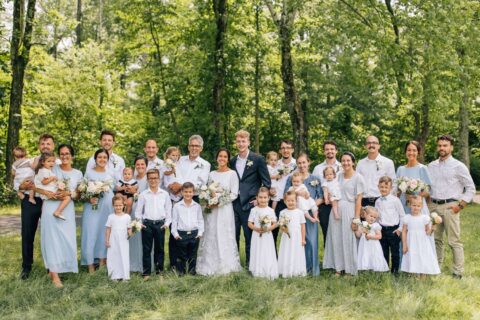 Ivan King surrounded by family in the woods