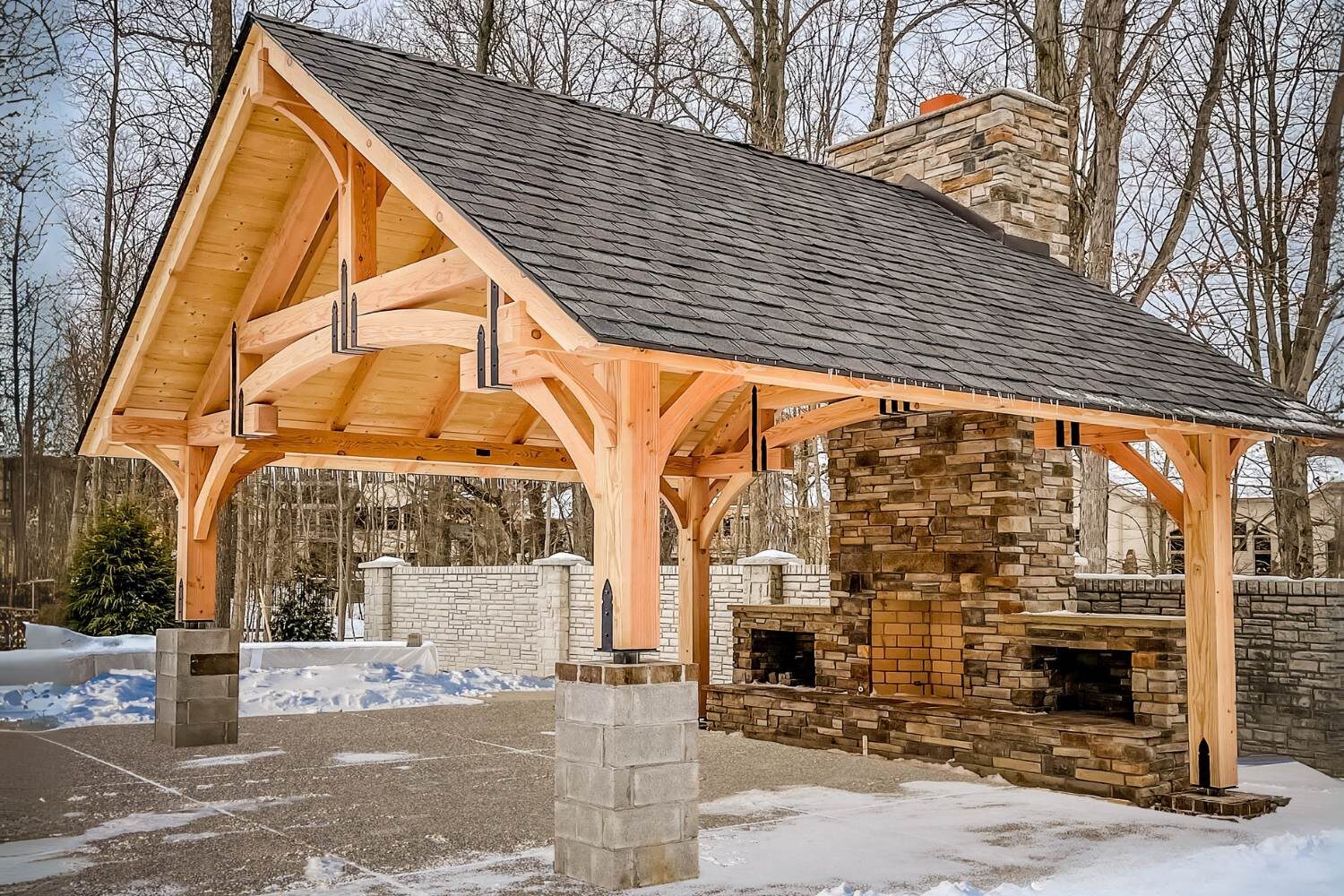 timber frame pavilion in the snow with fireplace