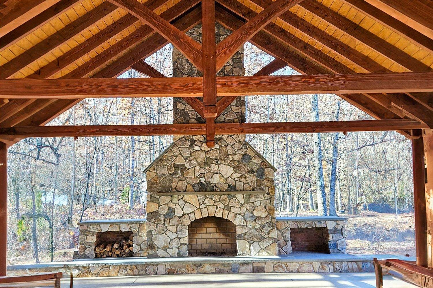 Timber frame pavilion with fireplace underneath