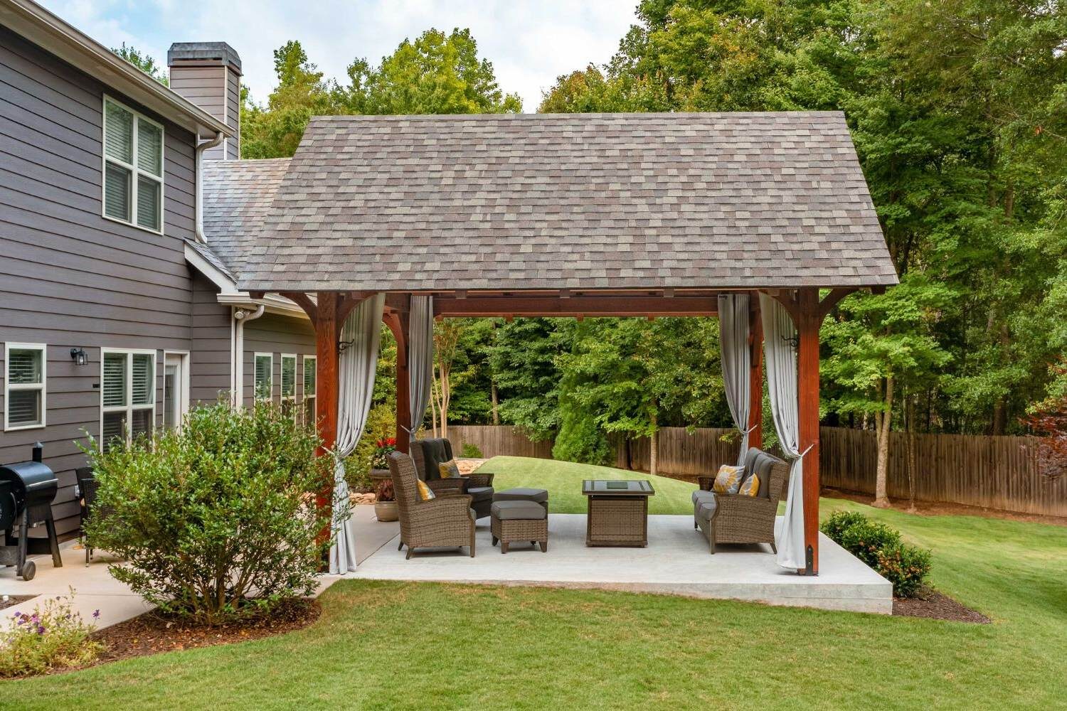 Kingston Timber frame kit pavilion from the side with curtains and seating
