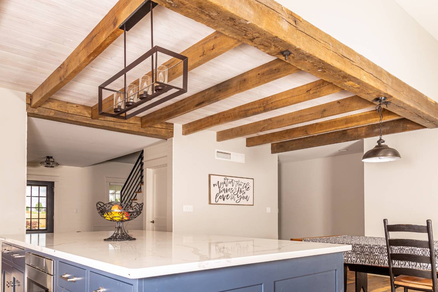 Timber Frame design addition inside home, above kitchen counter, in contrast to white ceiling