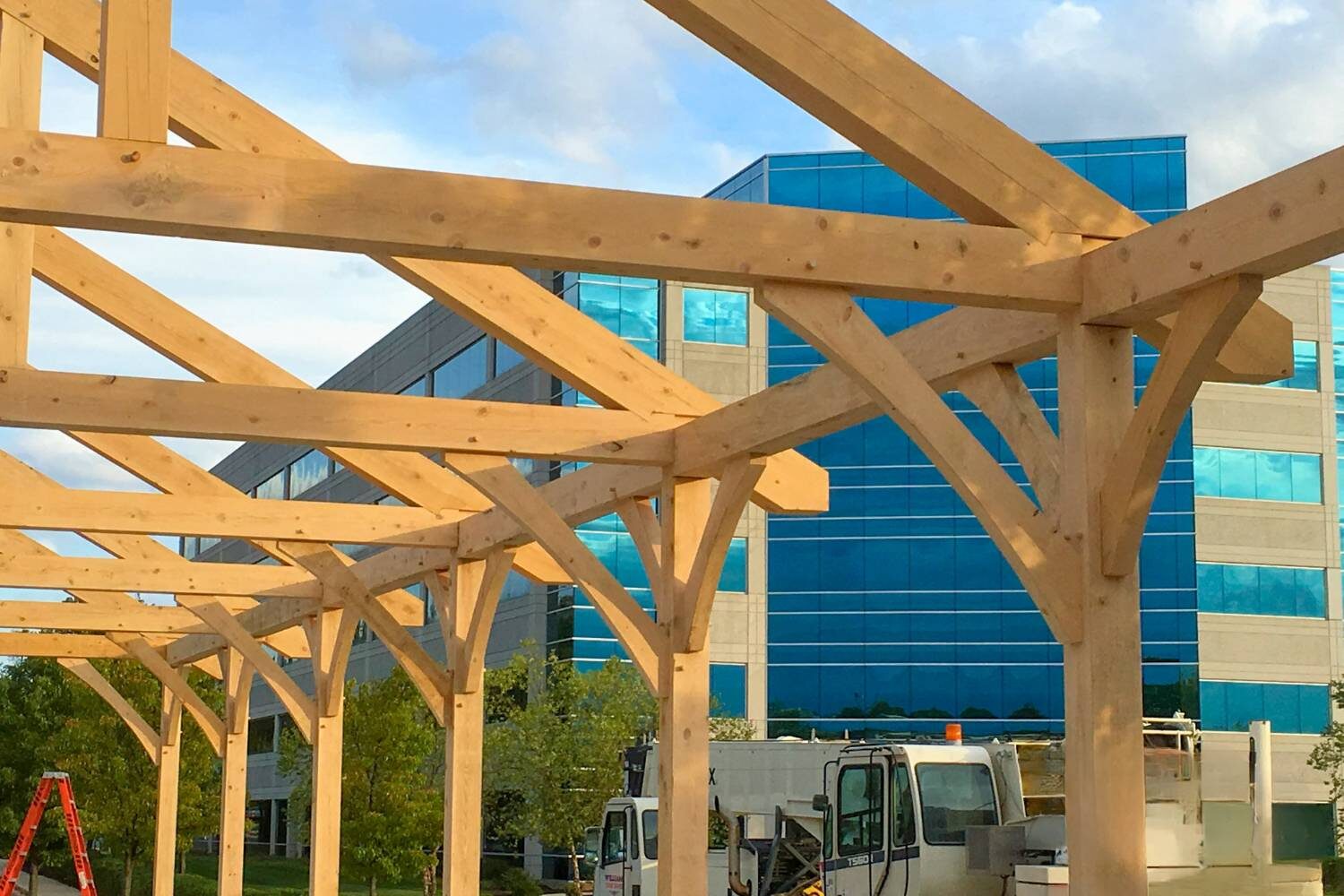 Underneath a timber frame pavilion during construction outside commercial building