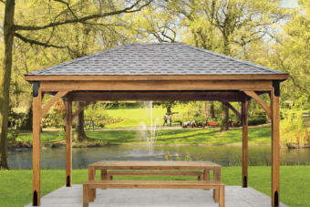 front of a lakefront patio pavilion for sale in a beautiful green yard