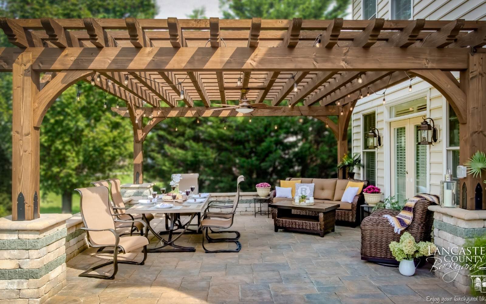 View of boulder pergola over patio seating area