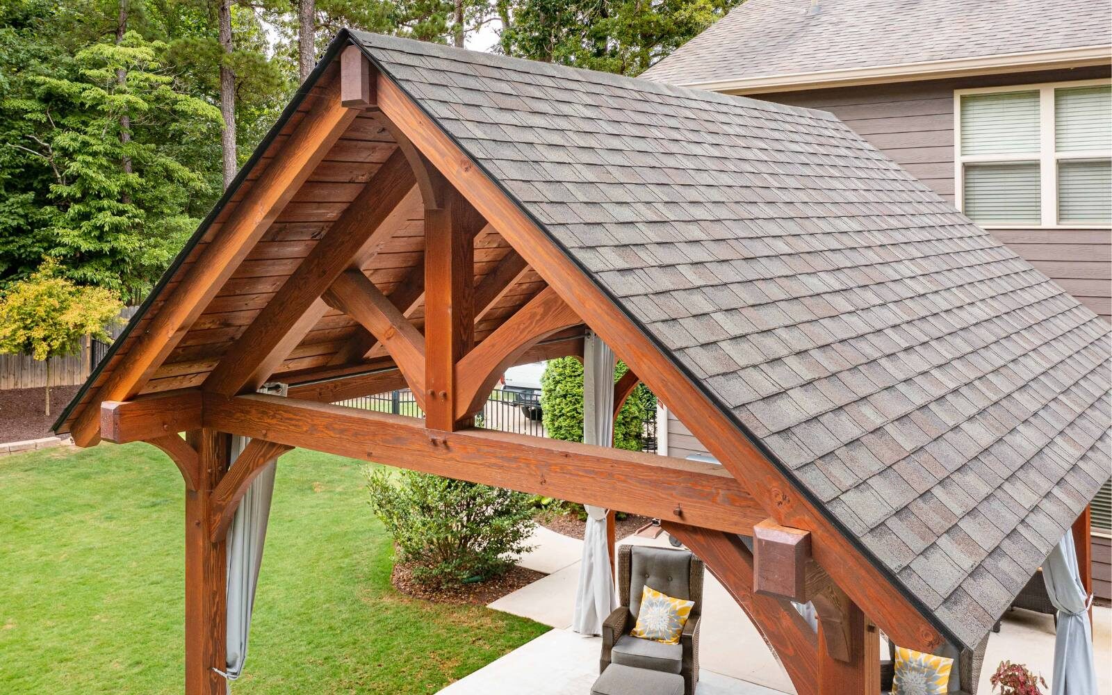 Aerial view of timber frame pavilion in family's backyard