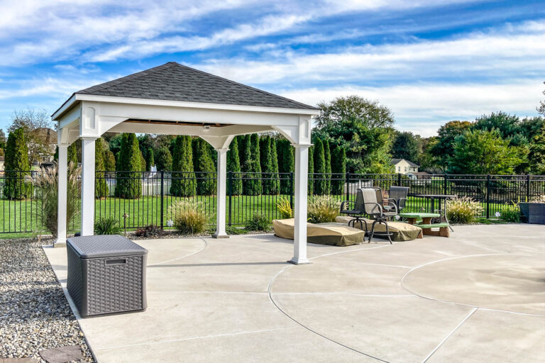 White vinyl pavilion angled view showing patio, surrounding landscape, and outdoor furniture in Woolwich Township, NJ.