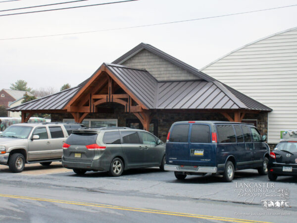 timber frame storefront with cars