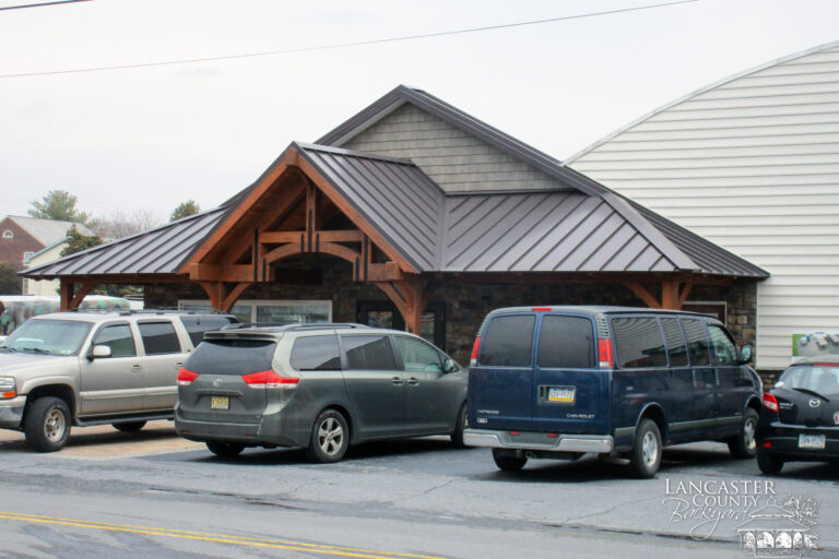 timber frame storefront with cars