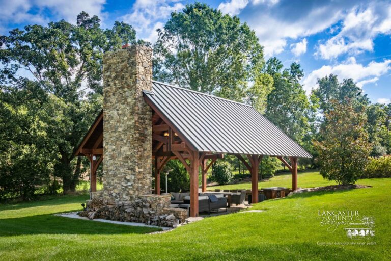 grand teton timber frame pavilion with a large fireplace and chimney