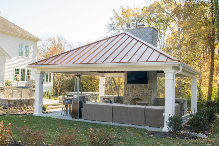 24×24 carbbean vinyl pavilion with red metal roof and a fireplace